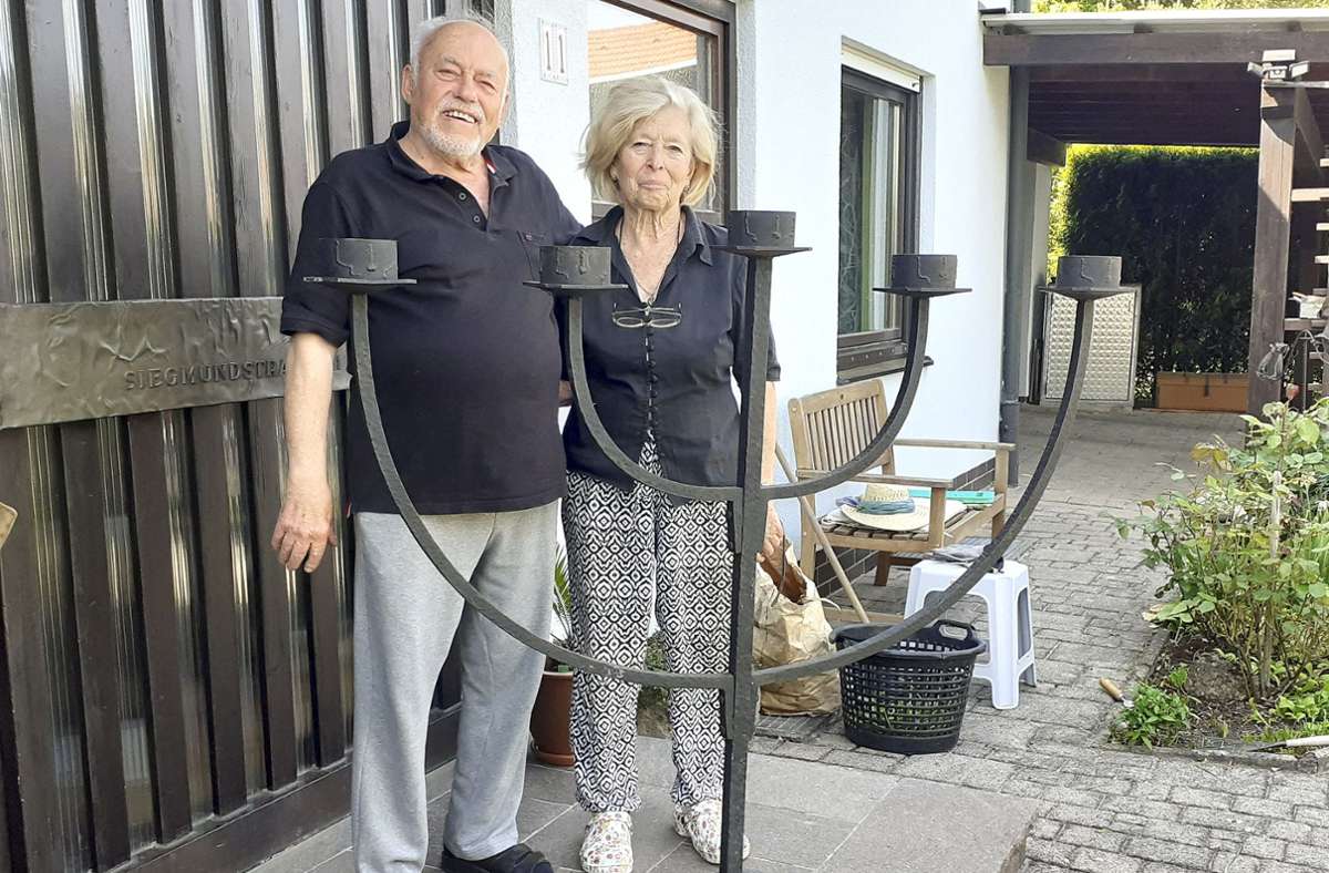 Gerhard und Christel Gollner mit dem schmiedeeisernen Leuchter vor der Haustür in Bayreuth. Der Leuchter steht jetzt in der Friedhofshalle in Thierstein. Foto: /Silke Meier